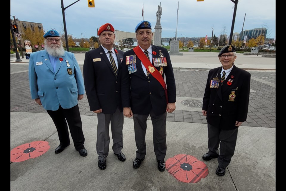 From left are Rev. Tom Huntley, Michel Cormier, Fern Taillefer and Mary-Florence Bartley represented the Barrie Royal Canadian Legion at the official unveiling of the poppy crosswalk, Tuesday, Nov. 9. 