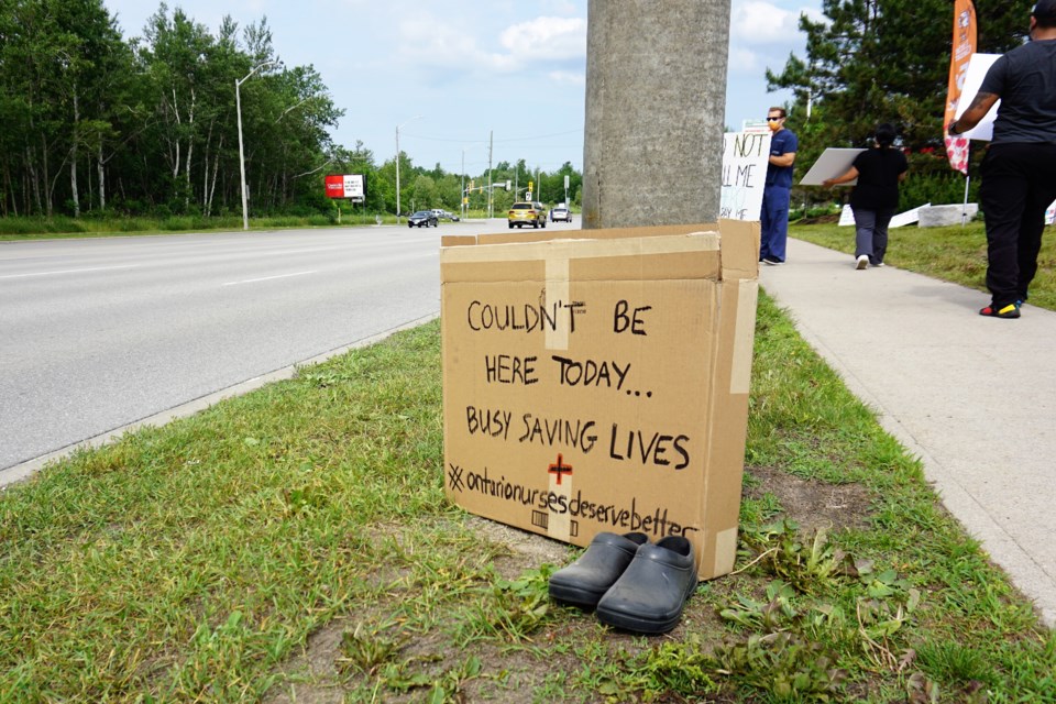 Nurses took to a busy section of Mapleview Drive and Huronia Road on Monday afternoon to protest Bill 124. Jessica Owen/BarrieToday   