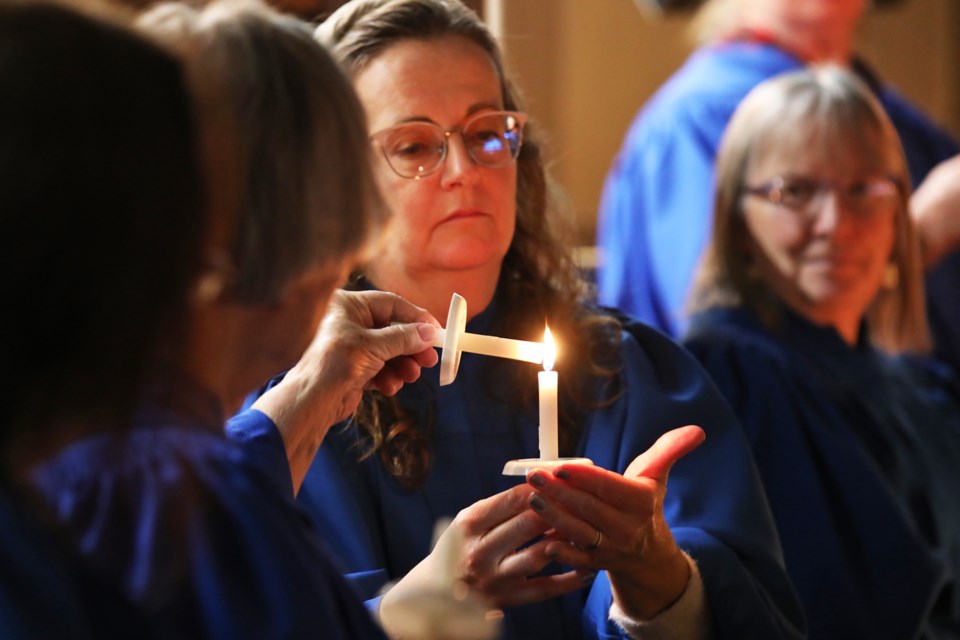 Candles are lit during last night's Christmas Eve service at St. Andrew's Presbyterian Church in downtown Barrie.