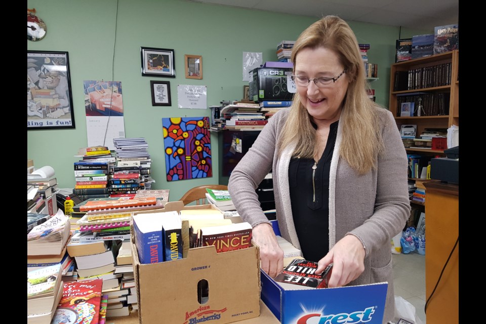 Wendy Cahill looks over some of the many books she gets everyday  from people looking to sell, Wednesday Jan. 15, 2020. Shawn Gibson/BarrieToday