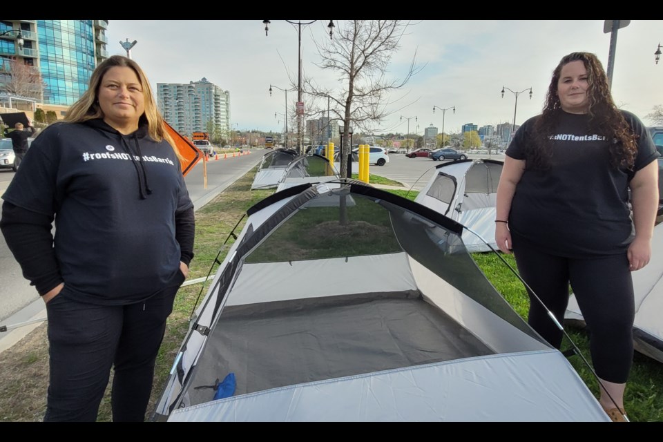 David Busby executive director Sara Peddle, left, and Elizabeth Fry executive director Meaghan Chambers wear their #RoofsNotTentsBarrie sweaters, Wednesday at the Barrie lakeshore.  