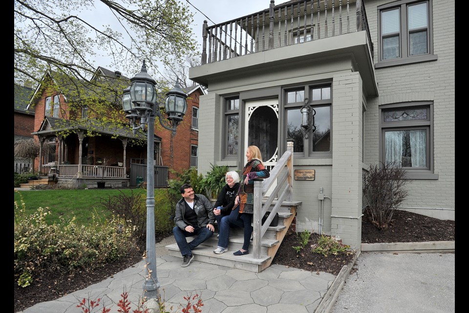 Allandale Neighbourhood Association members, Craig Froese, from left, Cathy Colebatch and Barbara Mackie take a break on a Cumberland Street century home.
IAN MCINROY/BARRIE TODAY files