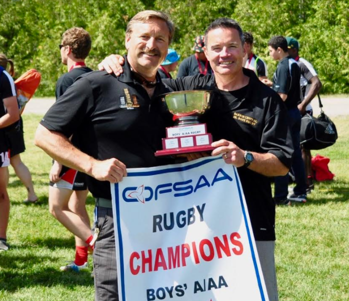 Steve Porter, left, and Ron Andrews celebrate Barrie Central’s ninth OFSAA boys rugby 
gold medal in 2015. Image supplied