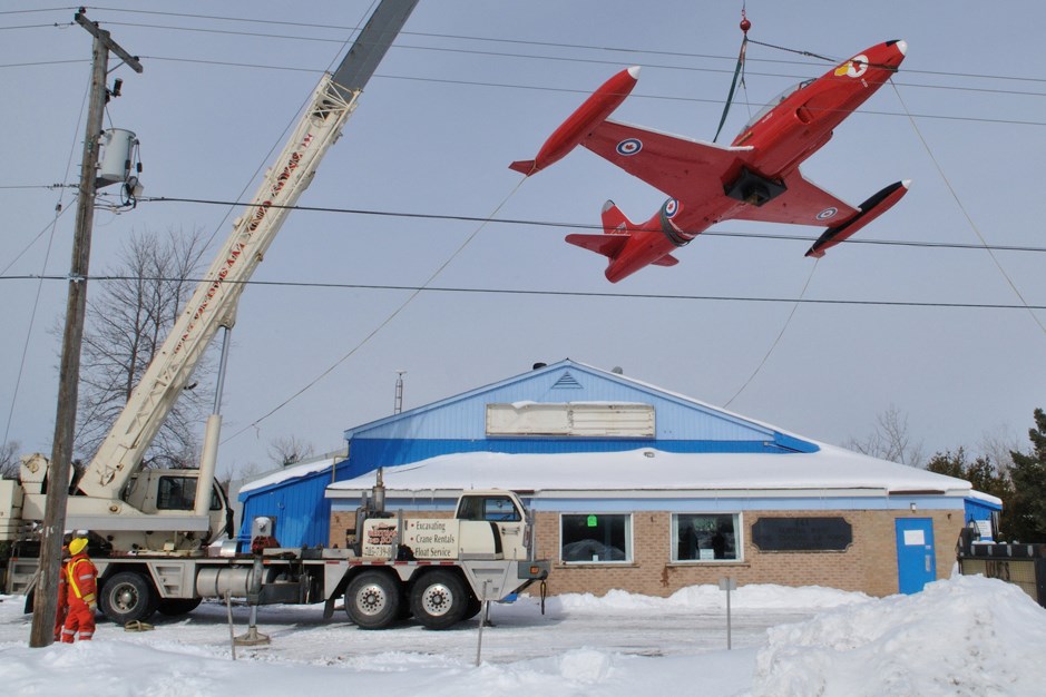 Canadian Armed Forces T-33 Red Knight is removed from its pedestal in 2009 in front of what was the 441 (Huronia) Wing, RCAF Association - Barrie building on Highway 90 west of Tiffin Street. DND Photo/Sgt. Kev Parle