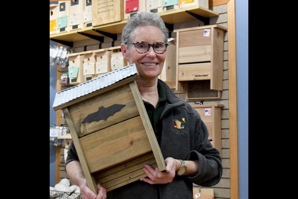 Anne Downey, of Wild Birds Unlimited, holds one of the shop's smaller bat houses.