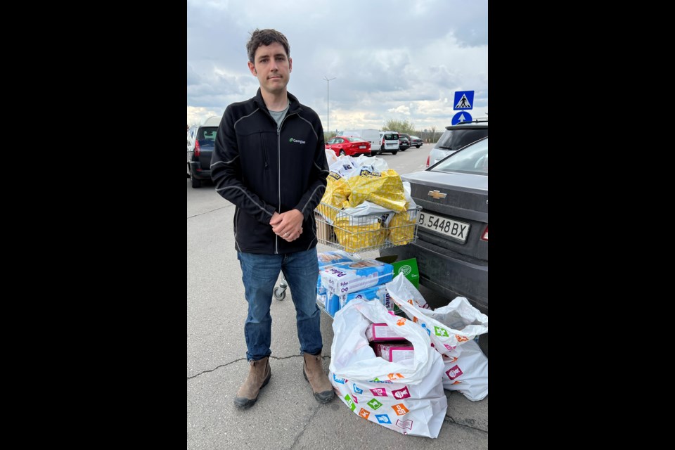 Former Barrie resident Don Komarechka stands next to supplies that he has purchased for a nearby refugee centre in the city of Varna, Bulgaria. He has been going on supply runs about three to fives times per week as donations are received.