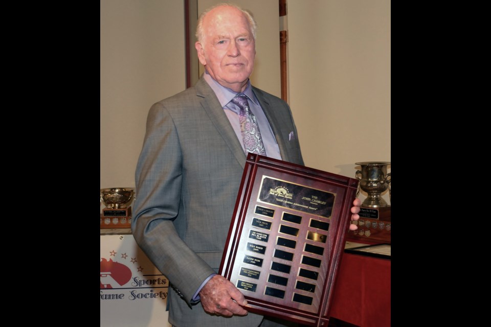 The late Don Roulston accepts the Barrie Sports Hall of Fame's John Crawley Lifetime Contribution Award in 2014 for his contribution to sport in Barrie.