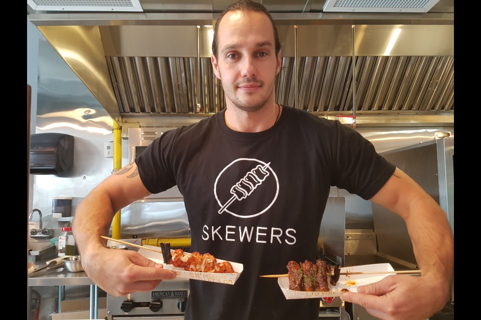 Luke Michorowski shows off two options at his new downtown eatery, Skewers, located on Clapperton Street. Shawn Gibson/BarrieToday