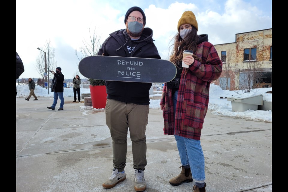 Dustin O'Donnell (left) and Natasha Bangay show their feelings at a downtown protest on Saturday in support of Skyler Kent, whose violent arrest was capture on video by several people on Thursday. 