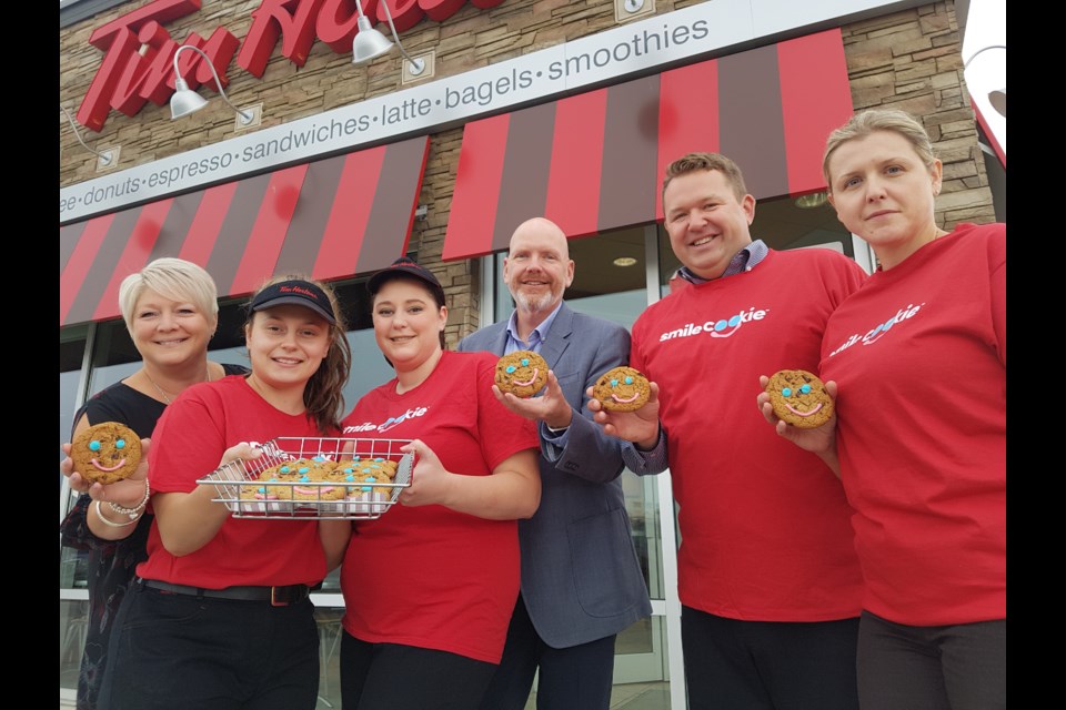 From left, Kelly Hubbard (Hospice Simcoe), Alexandra Sciacca, Valerie St. Hill, Eric Dean (RVH), Geoff House (Tim Hortons manager), Agnes House (Tim Hortons manager) show off freshly baked Smile Cookies. Shawn Gibson/BarrieToday
