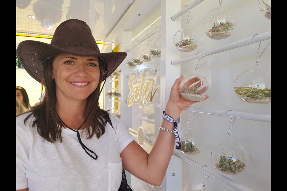 Megan McCrae of Aphria shows off one of the many components of the Solei Discovery Centre, located on the grounds of the Boots and Hearts Country Music Festival at Burl's Creek. Staff at the booth helped inform people about cannabis usage. Shawn Gibson/BarrieToday