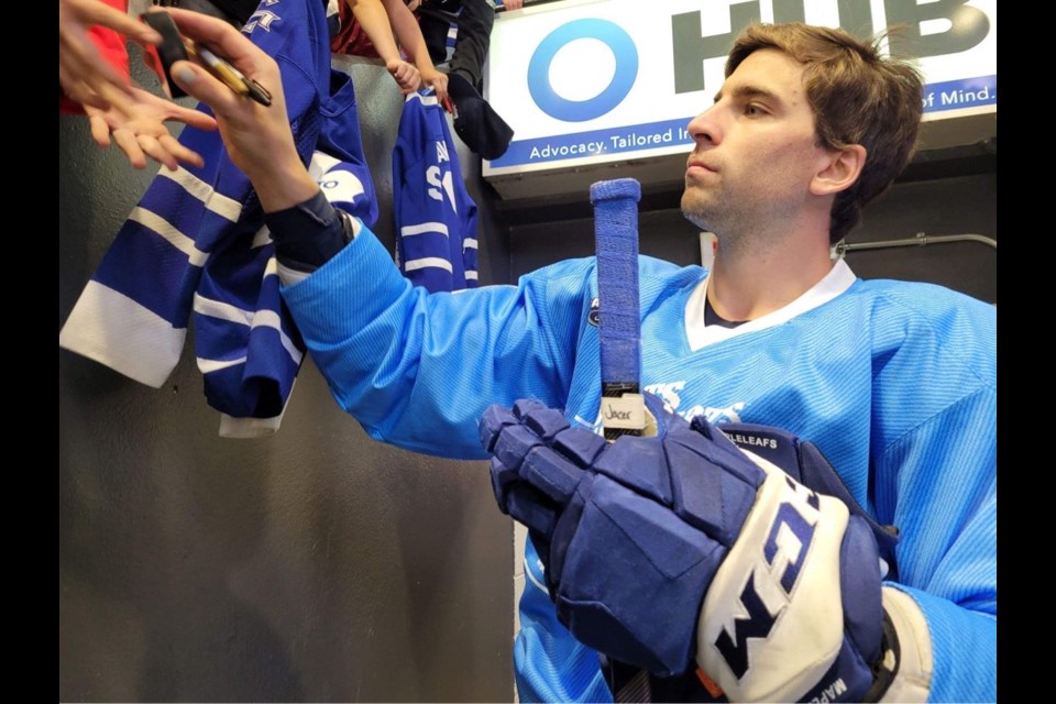Toronto Maple Leafs captain John Tavares signs autographs for fans at Wednesday night's Boots and Hearts Barn Burner charity hockey game at Sadlon Arena in Barrie. 