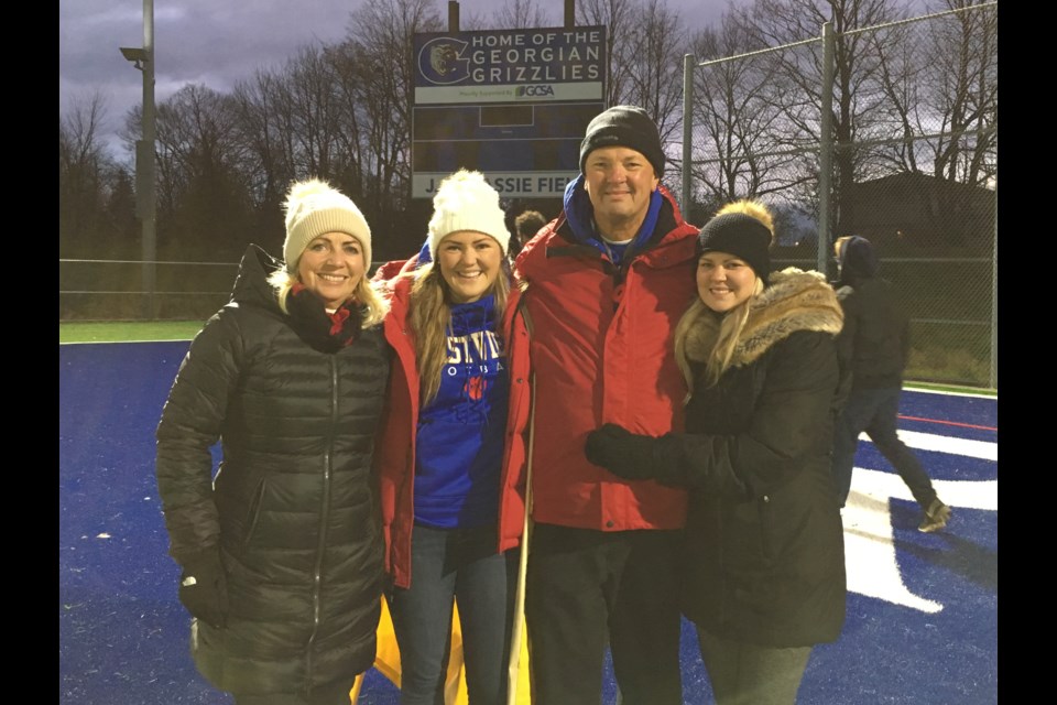 The late Martin Carl is shown with his family in an undated photo at Georgian College's J.C. Massie Field  in Barrie. 