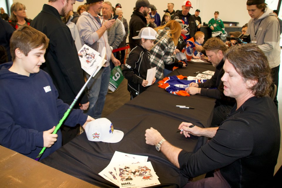 Players sign autographs for fans prior to the  NHL Alumni Hockey game at the new Wasaga Stars arena on Feb. 10, 2024.