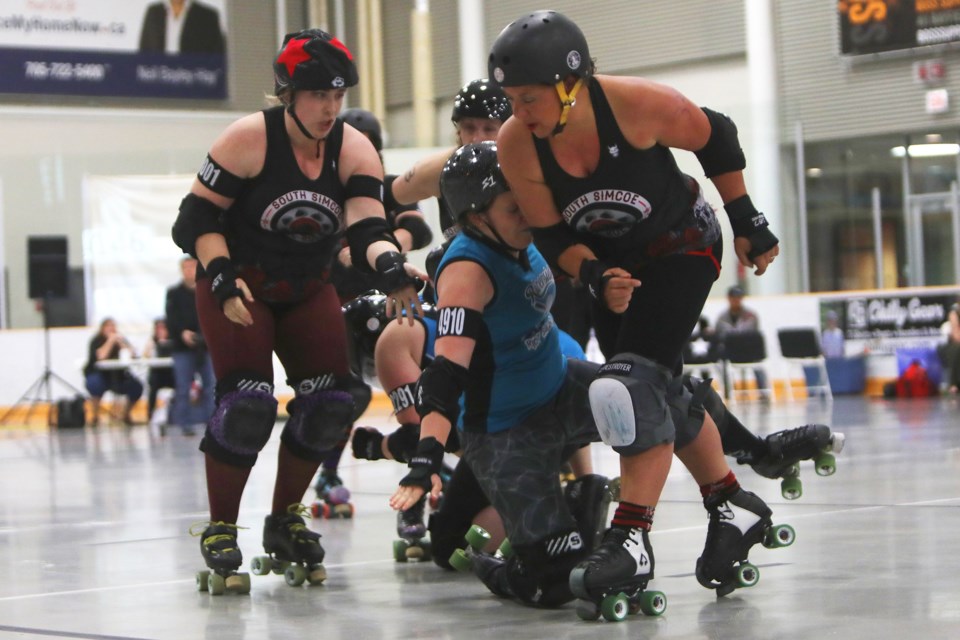 A Rebel player throws her body into an opponent during the South Simcoe Rebel Rollers roller derby match against Peterborough at the Holly Community Centre in Barrie on Saturday, May 12, 2018. The Rebels won 268 to 124. Kevin Lamb for BarrieToday.