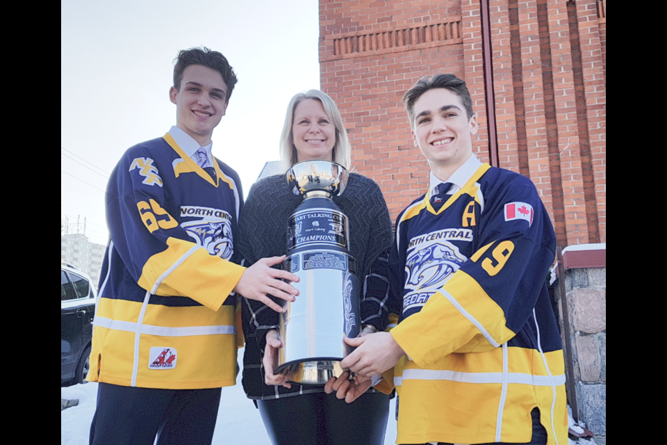 From left, Nicholas Dowlings, the CMHA's Liz Grummett and Cole Quevillon are shown with the Start Talking Cup in January 2020. Shawn Gibson/BarrieToday file photo
