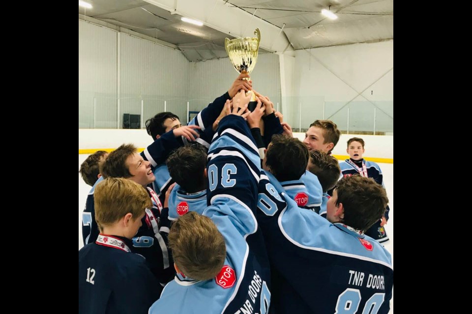 Barrie minor hockey players hoist the TNR Doors Trophy. Image supplied