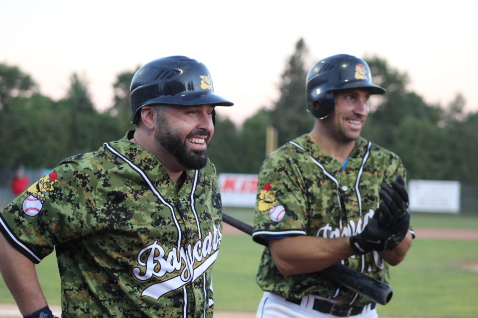 Barrie Baycats veterans Kyle DeGrace, left, and Ryan Spataro share a laugh with their teammates, Thursday night against the Brantford Red Sox. It was Military Night for the local Intercounty Baseball League team. The Baycats won, 16-14. Raymond Bowe/BarrieToday