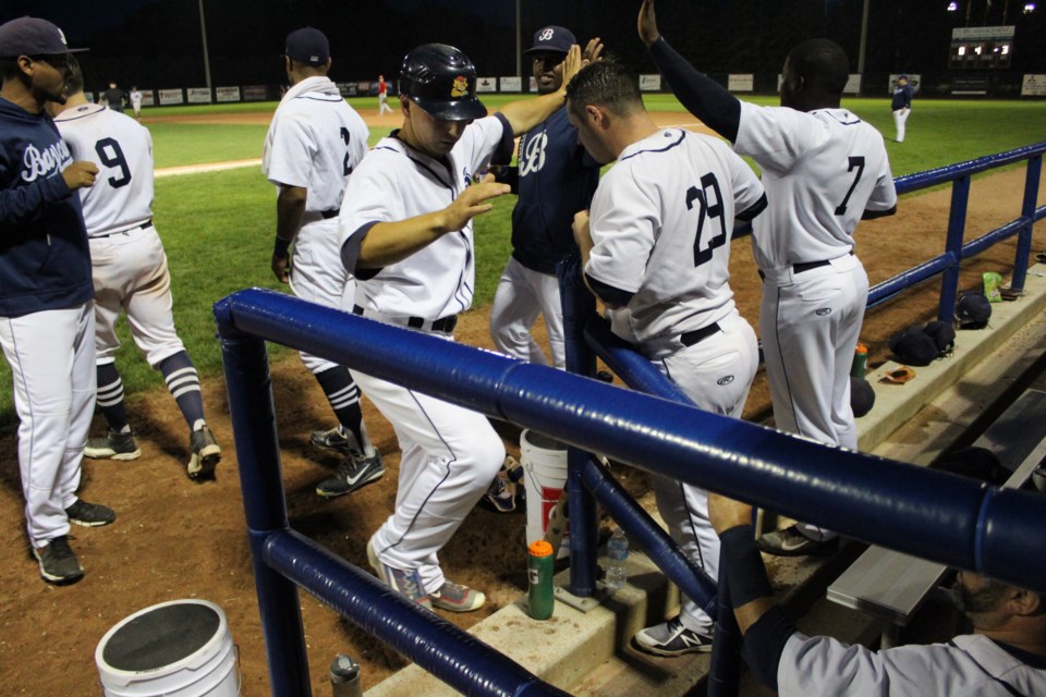 Jeff Cowan and the Barrie Baycats celebrate in the dugout en route to an 11-1 win in Game 1 of their IBL semifinal series against the Hamilton Cardinals. Raymond Bowe/BarrieToday
