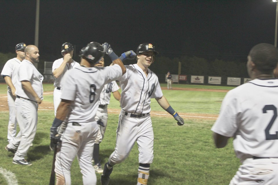 The Barrie Baycats' Conner Morro is swarmed by his teammates after blasting a grand slam on Thursday, Aug. 8, 2019 against the Brantford Red Sox in Game 1 of their first-round playoff series. Raymond Bowe/BarrieToday