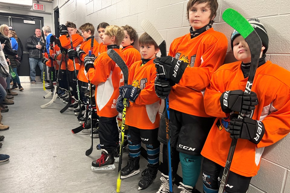 A team of young players wait to hit the ice with the Barrie Colts during the Colt for a Day event at Sadlon Arena on Sunday.