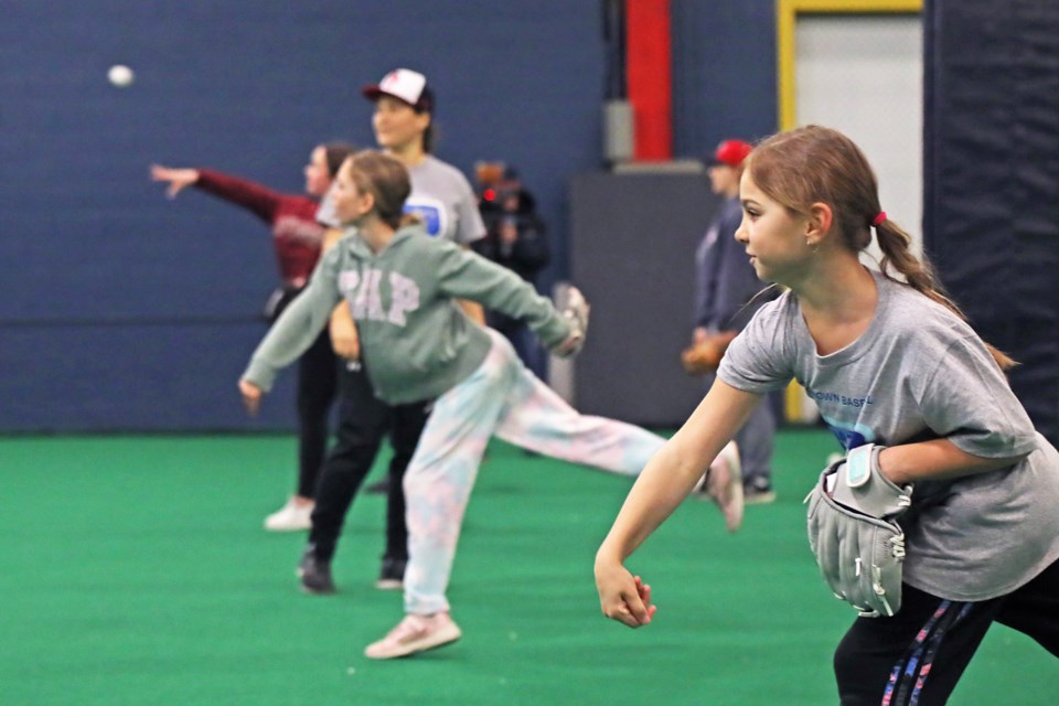 Participants practice throwing during the baseball clinic for girls hosted by Baseball Ontario on Saturday at Barrie Minor Baseball's practice facility at The Warehouse on Truman Road. | Kevin Lamb for BarrieToday