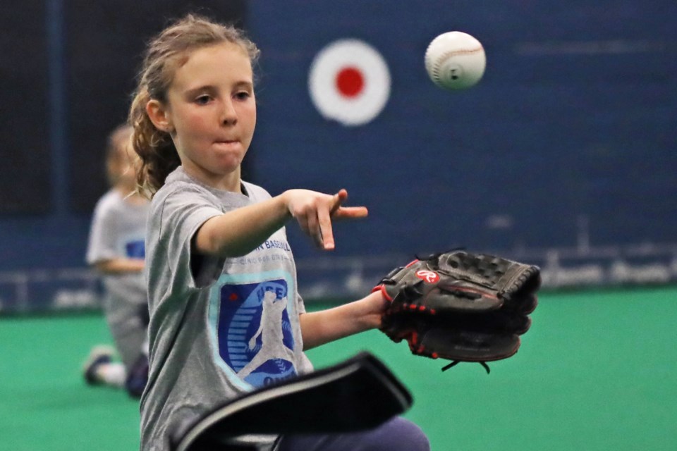 A youngster throws during the baseball clinic for girls hosted by Baseball Ontario on Saturday at Barrie Minor Baseball's practice facility at The Warehouse on Truman Road. | Kevin Lamb for OrilliaMatters