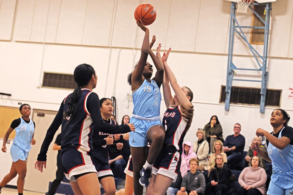 Essa Prep's Mariah Cross tries to make a shot during the new basketball team's first home game against Redmond at Innisdale Secondary School on Thursday evening.