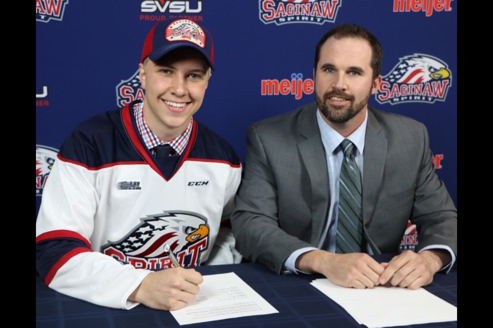 Saginaw Spirit General Manager Dave Drinkell is all smiles after Blade Jenkins signed a contract to play for the OHL team. Contributed photo