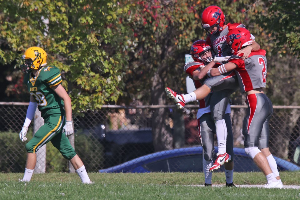 Bear Creek Kodiaks quarterback Justin Cunningham celebrates with teammates after he scored a touchdown against Barrie North Collegiate Institute on Friday, Sept. 29, 2023. The Kodiaks won their senior football game, 21-14.