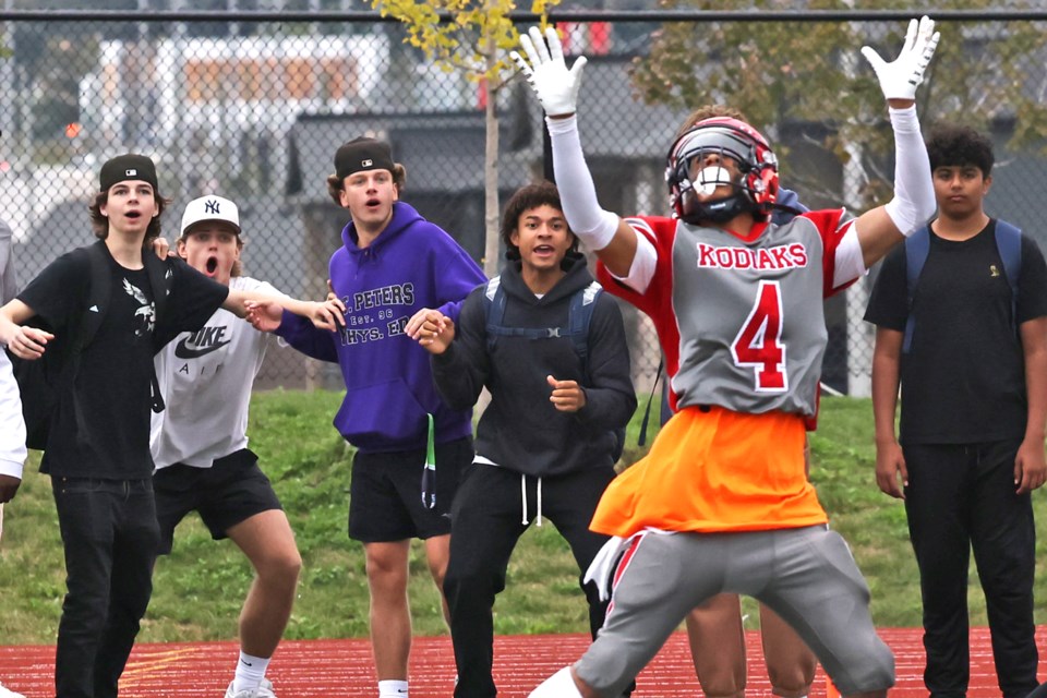 Fans on the sidelines admire a long pass as the Bear Creek Kodiaks visited the Maple Ridge Ravens Ravens during Simcoe County Athletic Association football action on Friday. The Kodiaks won 9-6.