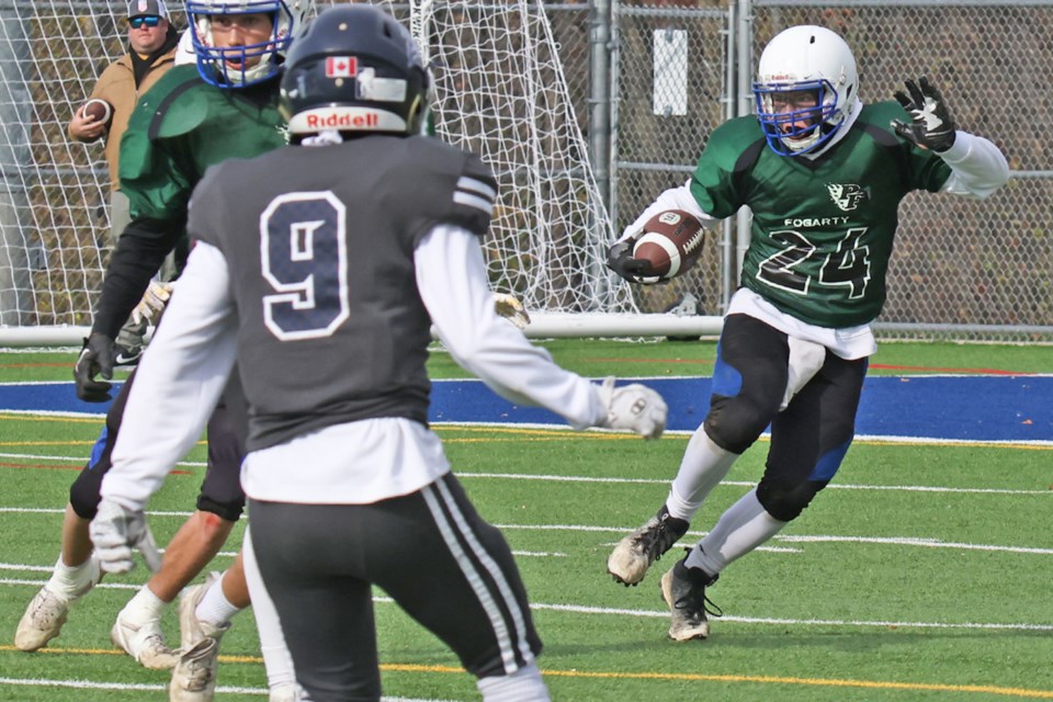 Patrick Fogarty Flames player Carson McGregor looks for a hole to run through during CSASC senior football playoff action against the St. Joan of Arc Knights on Friday at J.C. Massie Field in Barrie.