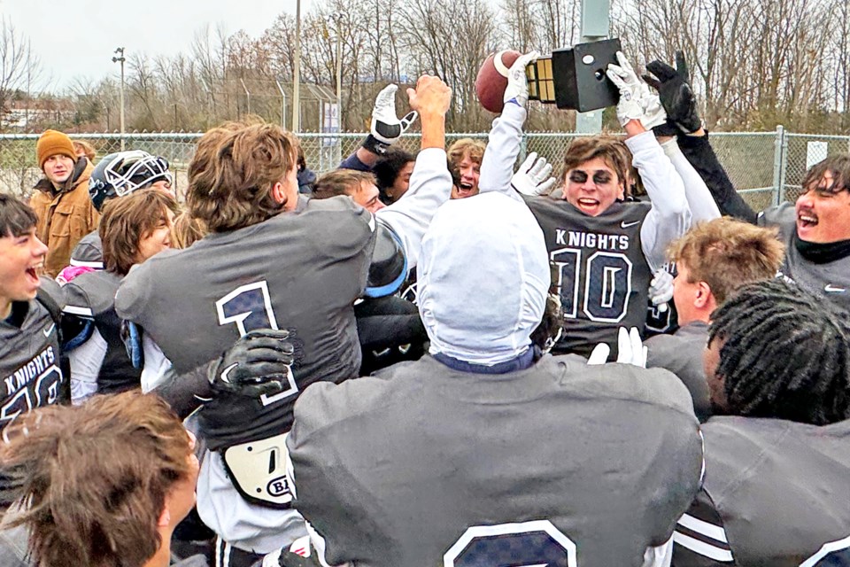Members of the St. Joan of Arc senior football team celebrate their Catholic School Athletics of Simcoe County (CSASC) championship win on Wednesday afternoon after defeating St. Joseph's, 28-3.