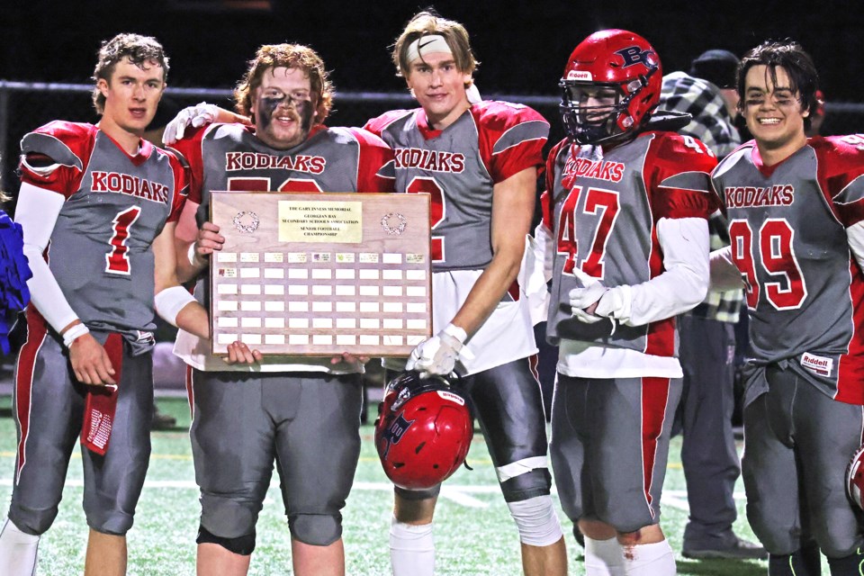 The captains of the Bear Creek Kodiaks senior football team accept the GBSSA plaque for the second year in a row, after beating the St. Joan of Arc Knights, 16-6, at J.C. Massie Field at Georgian College on Wednesday night. From left are  Justin Cunningham, Aidan Butt-Moore, Daniel Reilly, Ryan Stevens  and Anthony Khlivny.