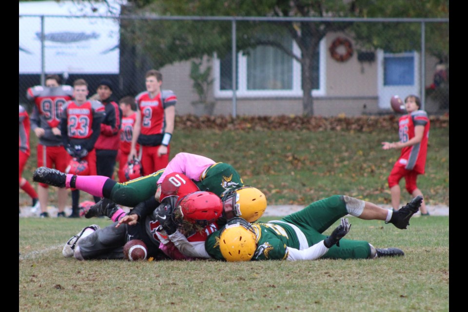 Bear Creek Kodiaks quarterback Lukus Dold is brought down by a pair of Barrie North Vikings during Simcoe County Athletic Association (SCAA) senior football action on Thursday, Oct. 17, 2019. Raymond Bowe/BarrieToday