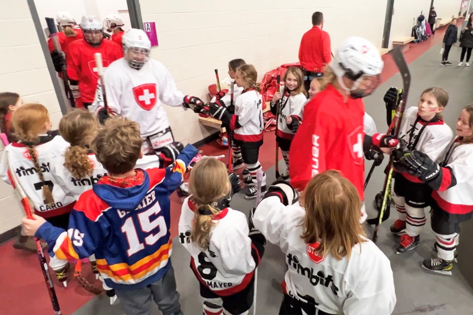Members of the U9 Orillia Hawks greet members of the Swiss national women's team as they hit the ice for practice at the Peggy Hill Team Community Centre on Mapleton Avenue, Sunday morning.