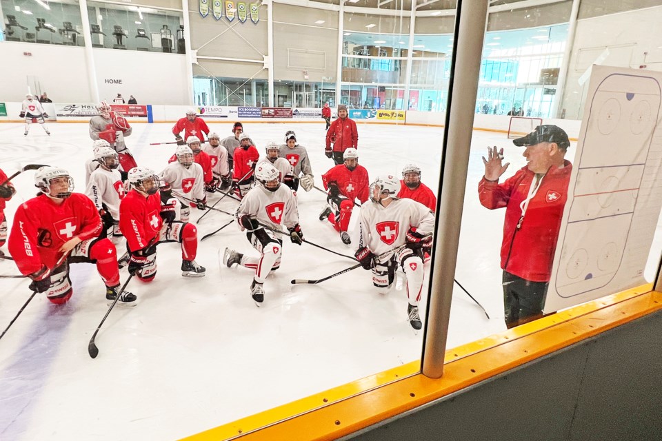 Members of the Swiss national women's team listen to their coach during their practice at the Peggy Hill Team Community Centre on Mapleton Avenue on Sunday morning. 
