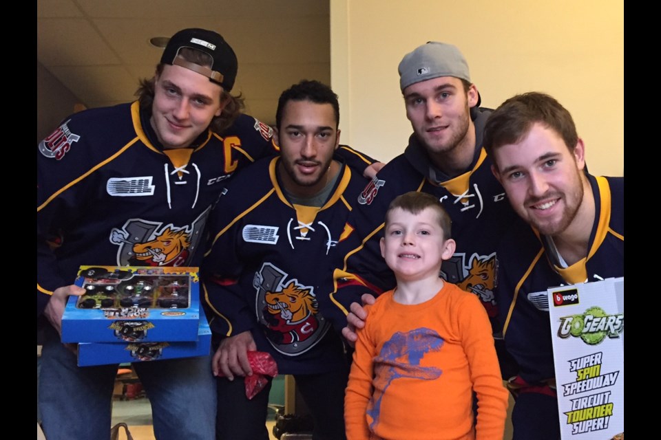 Barrie Colts players pose with 5-year old William Hilts at RVH. Sue Sgambati/BarrieToday