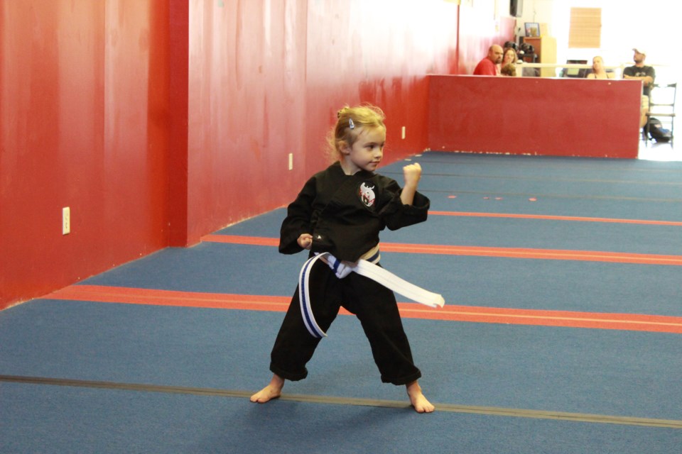 Izabell Sawden a student in RMA’s Little Dragon program demonstrates her techniques to her instructors earning her a new belt in the recent testing. Supplied photo