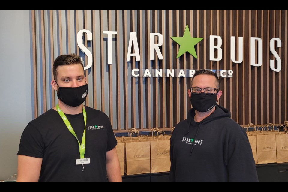 Star Buds manager Ryan Orr (left) and provincial general manager Jason Edgar help open the new location in east-end Barrie on Friday.