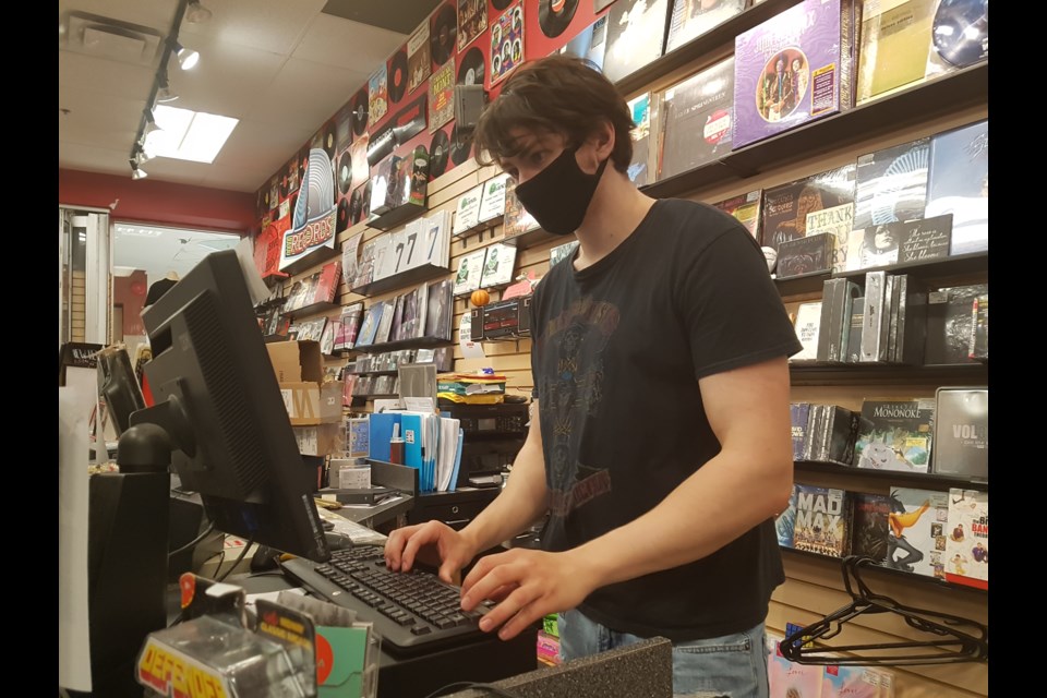 Sunrise Records employee Alex Crew wears his mask while working at the Bayfield Mall location, Sunday, June 21, 2020. Shawn Gibson/BarrieToday