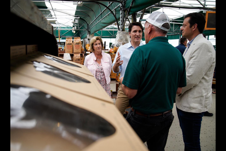 Prime Minister Justin Trudeau speaks with Barrie Hill Farms owner Morris Gervais as federal Economic Development Agency for Southern Ontario Minister Helena Jaczek, left, and Barrie Mayor Jeff Lehman  look on. Supplied Photo