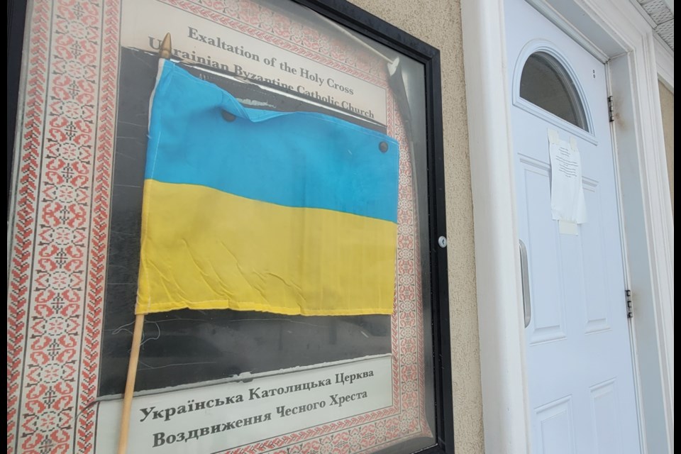 A Ukrainian flag welcomes those entering the Holy Cross Ukrainian Catholic Church on Parkside Drive.