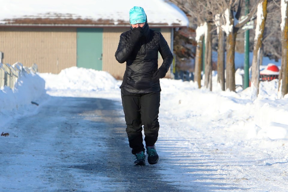 Jogger Charlene Vegter tries to keep warm as she runs along the lakeshore in Barrie on Saturday, Jan. 6, 2018, where temperatures hovered below -22 degrees Celsius.  Kevin Lamb for BarrieToday.