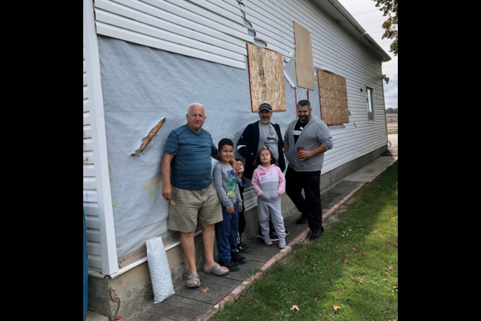 Rosario Galeota, pictured against his tornado-damaged wall with his sons, Alex and Andrés, and their children Michael, seven, Nicholas, four, and Mia, five, says he has been receiving prompt attention from his insurance company.