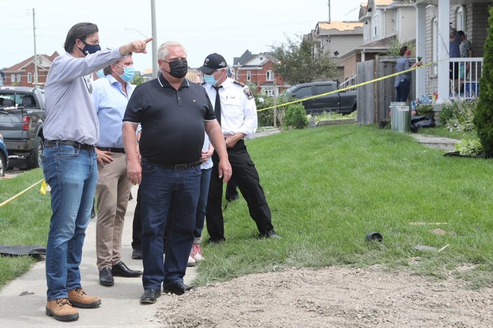 On Friday, Premier Doug Ford toured a neighbourhood in south Barrie devastated by an EF-2 tornado. Here he is shown touring the area with Barrie Mayor Jeff Lehman and emergency services personnel.