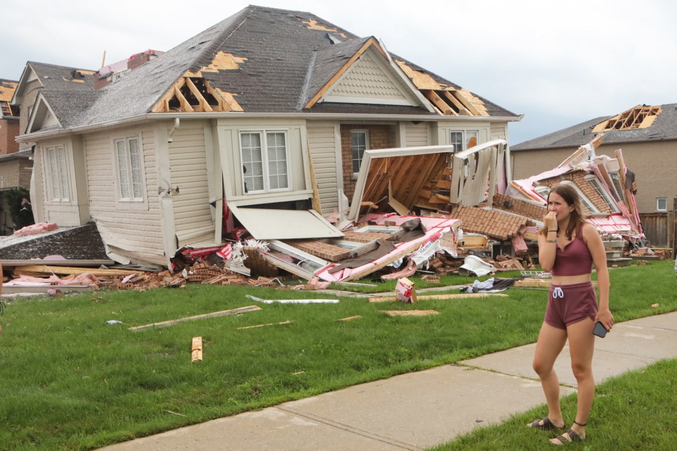 Stunned residents survey the damage after a tornado ripped through the south end of Barrie on Thursday afternoon.
