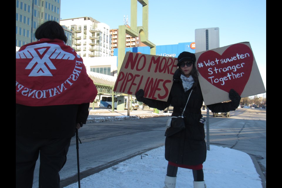 Sarah Cunnigham Gahondee  shows her support for the  Wet'suwet'en First Nation as she held signs on Collier Street, Saturday, Feb. 8, 2020. Shawn Gibson/BarrieToday                         