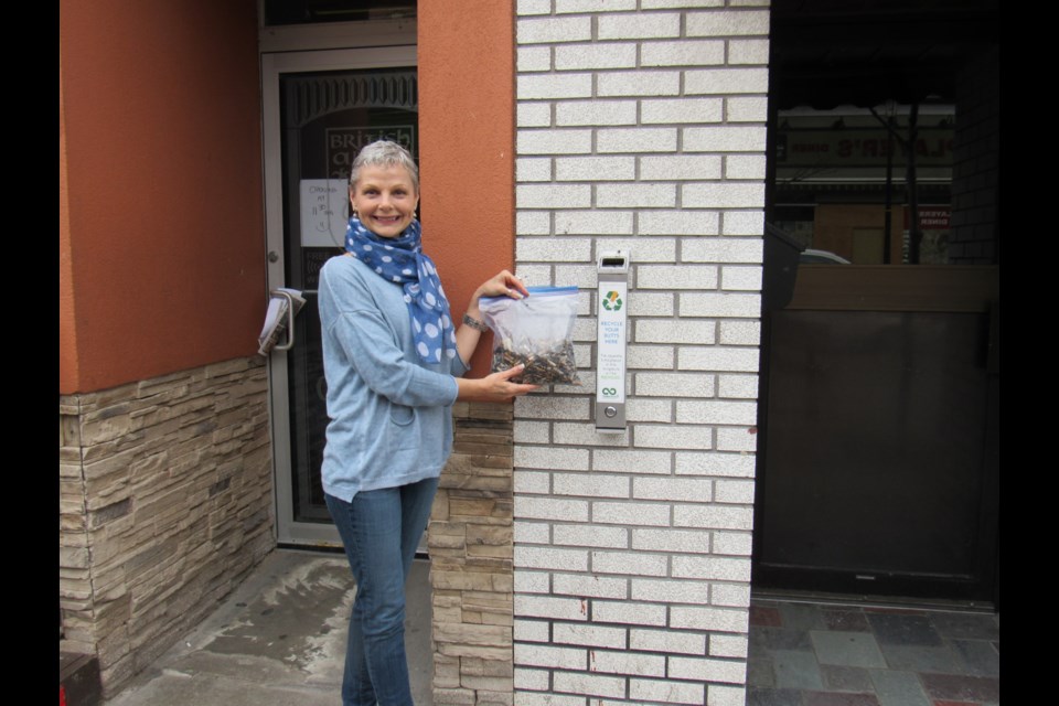 ZuZu's owner Tracey Baker beside her store's receptacle and the contents from one clean out                            