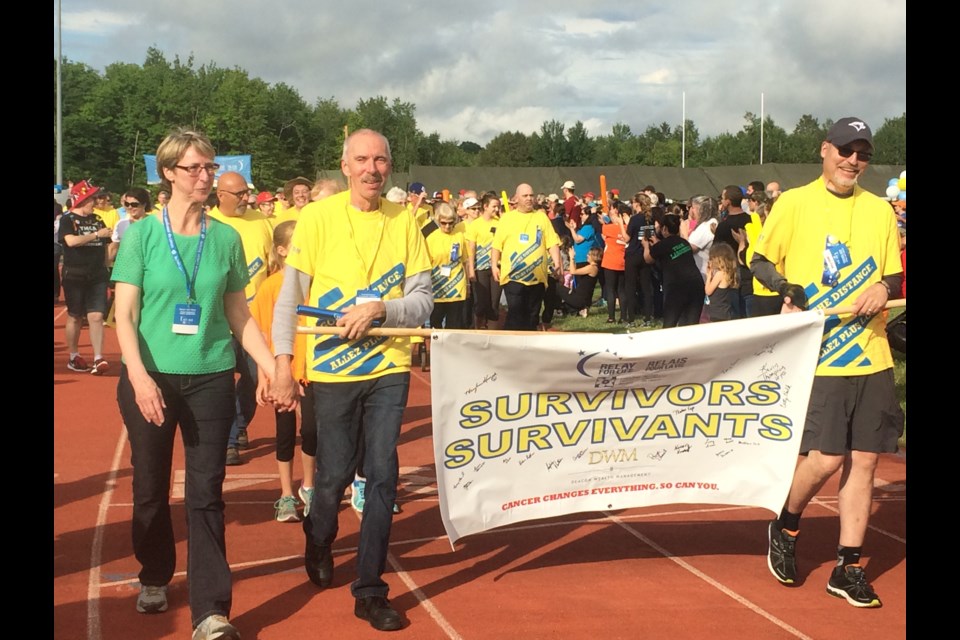 Relay for Life Honourary Survior Vern Vaillancourt and wife Cathy lead the survivors lap at 22 Wing 